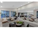 The open-concept living room with a view of the modern kitchen and a large comfortable seating area at 2518 Veronella St, Henderson, NV 89044