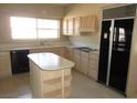 Traditional kitchen with an island, cabinetry, and modern appliances, offering functionality and style at 2830 Queens Courtyard Dr, Las Vegas, NV 89109