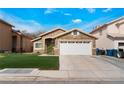 Charming single-story home with a two-car garage and well-maintained lawn at 2903 Galena Peak Ln, Las Vegas, NV 89156