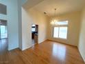 Spacious dining room with hardwood floors, chandelier lighting, and plenty of natural light at 2925 Big Green Ln, Las Vegas, NV 89134