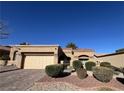 Charming single-story home with desert landscaping, a brick driveway, and an attached garage at 2925 Big Green Ln, Las Vegas, NV 89134
