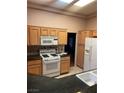 Functional kitchen featuring granite countertops, white appliances, and plenty of cabinet space at 2925 Big Green Ln, Las Vegas, NV 89134