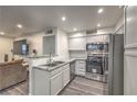 Modern kitchen with stainless steel appliances, granite countertops, and white cabinets at 3058 Tarpon Dr # 103, Las Vegas, NV 89120