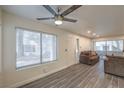 Inviting living room featuring a ceiling fan, large window, and cozy furniture at 3058 Tarpon Dr # 103, Las Vegas, NV 89120