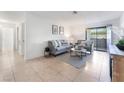 Bright living room with neutral decor, tile floors, and sliding glass doors at 3151 Soaring Gulls Dr # 1168, Las Vegas, NV 89128