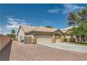 Attractive exterior of a single-Gathering home boasting a two-car garage, desert landscaping, and concrete driveway at 427 Rhythm St, Henderson, NV 89074
