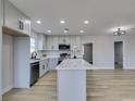 Bright open kitchen boasts an island with quartz counters, and modern stainless steel appliances at 4360 El Tovar Rd, Las Vegas, NV 89115