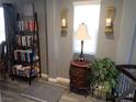 Cozy living room corner with ladder bookshelf, stylish decor, and a bright window at 4361 Duck Harbor Ave, North Las Vegas, NV 89031
