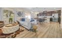 Inviting living area features natural light, wood floors, and open floor plan at 4465 Shimmering Skies St # 1177, North Las Vegas, NV 89031
