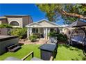 Secluded backyard oasis with artificial grass, seating, and a hot tub at 504 Painted Cloud Pl, Las Vegas, NV 89144