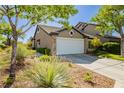 Charming single-story home with desert landscaping and a two-car garage at 504 Painted Cloud Pl, Las Vegas, NV 89144