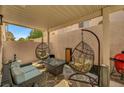 Relaxing covered patio features cozy seating arrangements, perfect for outdoor lounging and entertaining at 506 Chestnut View Pl, Henderson, NV 89052
