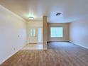 Open entryway features tile flooring and a cozy carpeted living room at 5704 Burdel St, Las Vegas, NV 89149