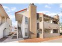 Exterior view of apartment building with tan chimney feature and red-tiled roof at 611 Bass Dr # C, Henderson, NV 89014