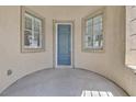 Inviting entrance with a blue front door, flanked by windows with white shutters, offering a bright welcome at 6150 Bunker Commons Ct, Las Vegas, NV 89108