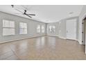 Spacious living room with large windows, tile floors, ceiling fan, and a bright, airy atmosphere at 6150 Bunker Commons Ct, Las Vegas, NV 89108