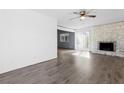 Open living room with wood floors, lots of light, and a charming fireplace at 6223 Foothill Blvd, Las Vegas, NV 89118