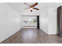 Bright living room featuring wood floors, ceiling fan, and a comfortable window seat at 6223 Foothill Blvd, Las Vegas, NV 89118