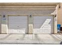 Two-car garage with white doors, showing unit numbers and concrete driveway at 6420 Extreme Shear Ave # 102, Henderson, NV 89011