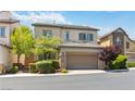 Attractive two-story home showcasing a two-car garage, stone detailing, and lush, green landscaping at 6731 Sumatra St, Las Vegas, NV 89166