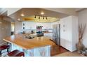 Bright kitchen features butcher block island, white cabinetry, and stainless steel appliances at 6901 Cobre Azul Ave # 202, Las Vegas, NV 89108