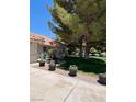 Beautiful home exterior with lush landscaping and charming details at 7650 Butterscotch Ct, Las Vegas, NV 89131