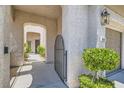 A gated entryway leads to a front door with a covered porch, next to a two car garage at 841 Colina Alta Pl, Las Vegas, NV 89138