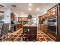 Spacious kitchen featuring wood cabinets, stainless steel appliances, and a large center island at 884 E Robindale Rd, Las Vegas, NV 89123