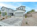 Two-story home showcasing paved driveway, xeriscaping, and gray exterior at 8909 Cherry Barn St, Las Vegas, NV 89113