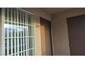 Apartment 209 entryway features door and window with blinds in neutral color scheme at 9070 Spring Mountain Rd # 209, Las Vegas, NV 89117