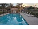 Community swimming pool with lounge chairs and shade. Perfect for relaxation and recreation at 9070 Spring Mountain Rd # 209, Las Vegas, NV 89117