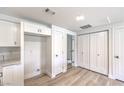 Spacious kitchen with white cabinets, white quartz countertops and wood-look flooring at 9303 Gilcrease Ave # 1243, Las Vegas, NV 89149