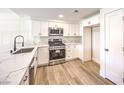 Beautiful kitchen with white cabinets, stainless steel appliances and a quartz countertop with a black faucet at 9303 Gilcrease Ave # 1243, Las Vegas, NV 89149