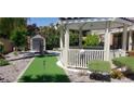 Outdoor area with green space, a quaint gazebo, and garden area providing a perfect space for relaxation at 10015 Wonderful Day Dr, Las Vegas, NV 89148