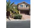 Beautiful two-story home featuring desert landscaping, a brick driveway, and a tile roof at 10974 Fintry Hills St, Las Vegas, NV 89141
