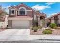Inviting front exterior with a two-car garage, desert landscaping and tile roof at 124 Wynntry Dr, Henderson, NV 89074