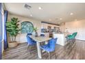 Dining room with open floor plan, views into kitchen, and luxury vinyl flooring at 1433 Gable Falls Pl # 95, North Las Vegas, NV 89084