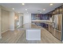Modern kitchen featuring stainless steel appliances, granite countertops, and spacious island perfect for entertaining at 1525 Spiced Wine Ave # 19103, Henderson, NV 89074