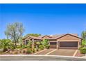 Charming single-story house with a well-manicured lawn, two-car garage, and a tile roof at 1564 Fieldbrook St, Henderson, NV 89052