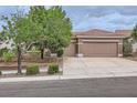 Charming single-story home showcasing a three-car garage, a well-maintained lawn, and a neutral color palette at 2110 King Mesa Dr, Henderson, NV 89012