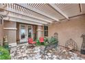 Inviting outdoor patio with a pergola, stone pavers, comfortable seating, and stylish decor at 2110 King Mesa Dr, Henderson, NV 89012