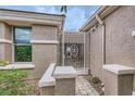 Side entrance features a decorative metal gate, a desert-scape, and neutral tones at 2110 King Mesa Dr, Henderson, NV 89012