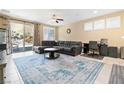 Spacious living room with tile floors, a ceiling fan, neutral paint, and sliding glass doors at 2128 Delmar Farms Ct, Laughlin, NV 89029