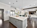 Open kitchen concept with marble island, stainless appliances, seamlessly flowing into a dining and living area at 220 Villa Borghese St, Las Vegas, NV 89138