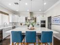 Modern kitchen features a spacious island with seating, stainless steel appliances, and pendant lighting at 220 Villa Borghese St, Las Vegas, NV 89138