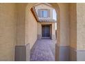 Inviting front entrance with a brick pathway leading to a double door under an arched portico at 242 Polaris Ridge Ave, Henderson, NV 89011