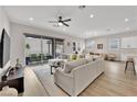 Bright living room featuring modern furniture, sleek flooring, and sliding glass doors at 2654 Summit Springs St, Henderson, NV 89044