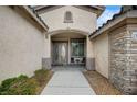 Inviting front porch with double doors, exterior stone accents, and space for seating at 2939 Crown Bluffs Ct, Las Vegas, NV 89117