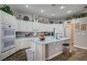 Bright kitchen with an island, white cabinetry, double ovens, and modern appliances at 2939 Crown Bluffs Ct, Las Vegas, NV 89117