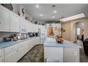 Bright kitchen with white cabinets, a light countertop island, and lots of space for storage at 2939 Crown Bluffs Ct, Las Vegas, NV 89117